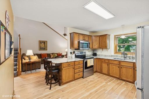 Here's a photo from the kitchen w/views into the vaulted family room and staircase.