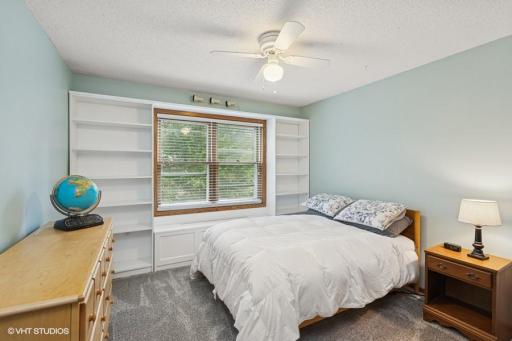 BR2 has wall of shelves & window facing the back yard.