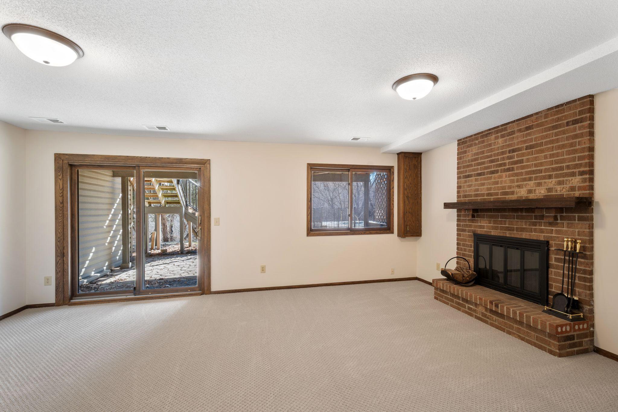 Lower level bedroom with a fireplace and walkout entry/exit.