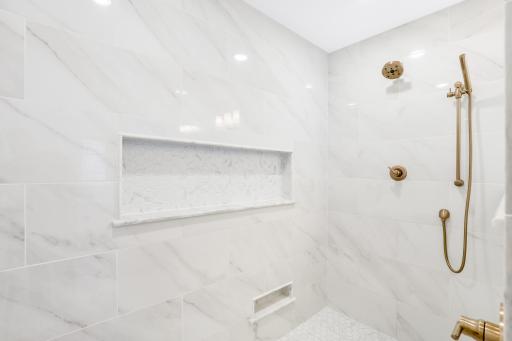 The private bath features heated floors, a large walk-in shower, double vanities and a separate soaking tub.