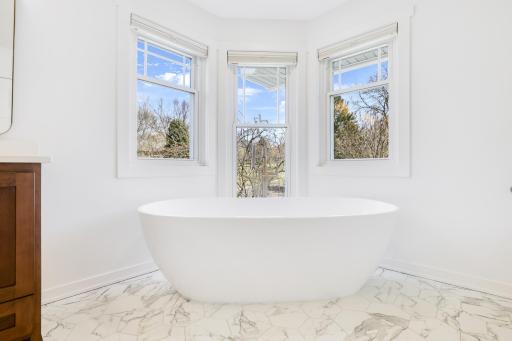 The private bath features heated floors, a large walk-in shower, double vanities and a separate soaking tub.