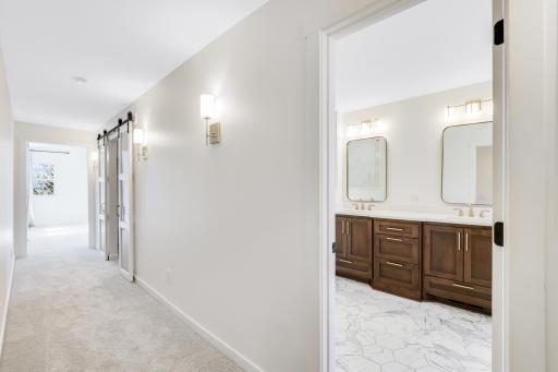 The massive ownerâs suite on the upper-level features a walk-in closet and private bath with heated floors, a large walk-in shower, double vanities and a separate soaking tub.