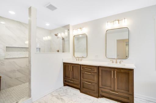 The private bath features heated floors, a large walk-in shower, double vanities and a separate soaking tub.