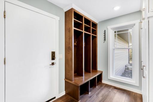 The mudroom off of the kitchen features pantry storage (right) and access to the garage.