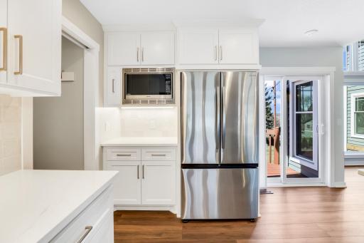 The fully remodeled chefâs kitchen features custom cabinets, quarts tops, a massive island, double ovens, a 6-burner Thermador cooktop, a custom fanhood, a 32-cubic-foot refrigerator, under cabinet lighting, a pantry in the mudroom, and more.