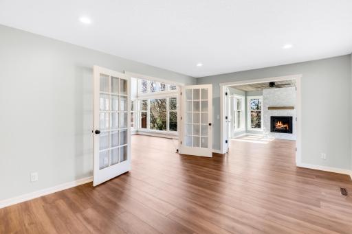 The main floor family room can be used as a flex space and walks through to the 4-season sunroom.