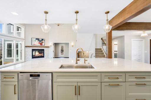 The fully remodeled chefâs kitchen features custom cabinets, quarts tops, a massive island, double ovens, a 6-burner Thermador cooktop, a custom fanhood, a 32-cubic-foot refrigerator, under cabinet lighting, a pantry in the mudroom, and more.