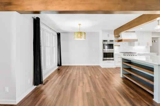 The fully remodeled chefâs kitchen features custom cabinets, quartz tops, a massive island, double ovens, a 6-burner Thermador cooktop, a custom fanhood, a 32-cubic-foot refrigerator, under cabinet lighting, a pantry in the mudroom, and more.