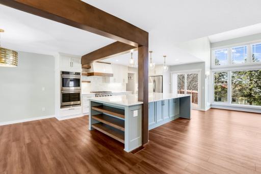 The fully remodeled chefâs kitchen features custom cabinets, quartz tops, a massive island, double ovens, a 6-burner Thermador cooktop, a custom fanhood, a 32-cubic-foot refrigerator, under cabinet lighting, a pantry in the mudroom, and more.