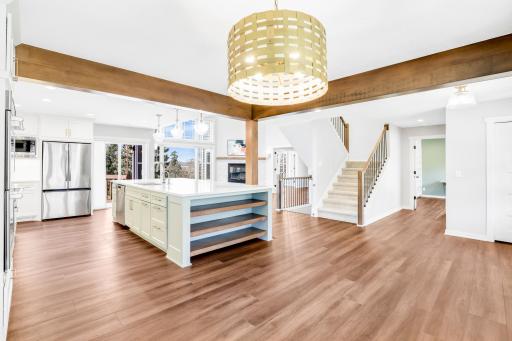 The fully remodeled chefâs kitchen features custom cabinets, quartz tops, a massive island, double ovens, a 6-burner Thermador cooktop, a custom fanhood, a 32-cubic-foot refrigerator, under cabinet lighting, a pantry in the mudroom, and more.