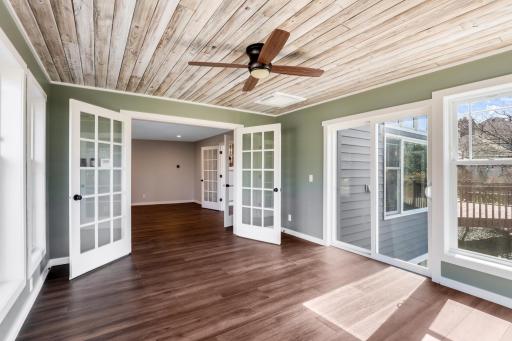 The sunroom is surrounded by windows, features a gas fireplace, and a glass door for a future deck expansion.