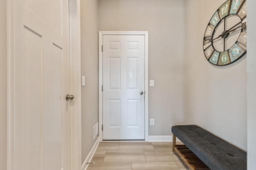 Mudroom with spacious walk-in closet and garage access.
