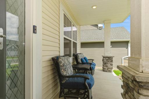 Stately concrete front porch with stone pillars - perfect for morning coffee!