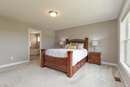 Another view of primary bedroom showing entrance to the private full bath.