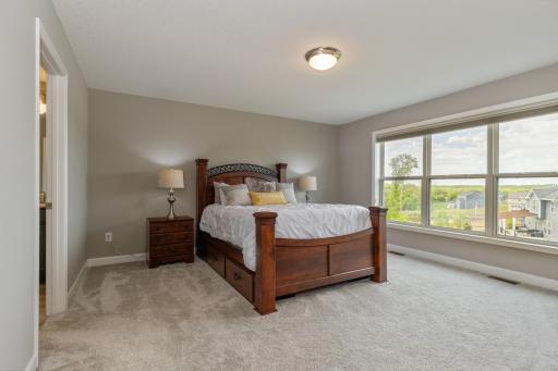 There are 4 bedrooms on the upper level including the primary bedroom suite. This room has large windows offering an abundance of natural light.