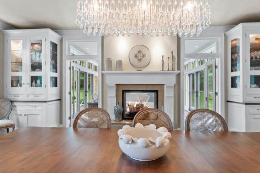 Two sided fireplace connects dining and sunroom!