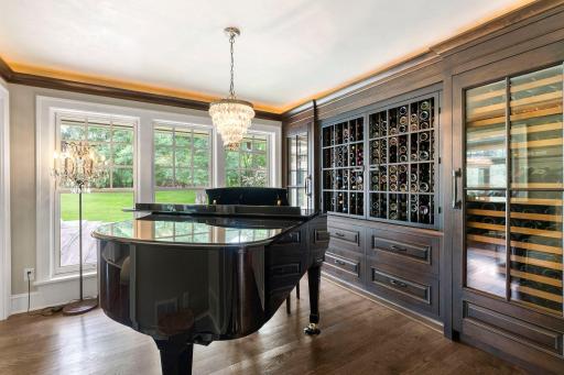 Wine and music room offers two offers two Sub-Zero wine chillers and walnut cubbies!