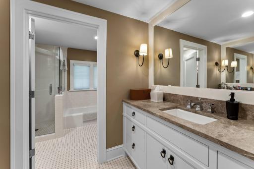 Full bath with glass shower and tub located between bedrooms!