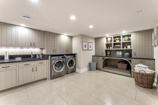 Laundry area has unlimited cabinets and counters!