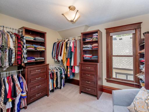 Large walk-in closet with built-in shelving.
