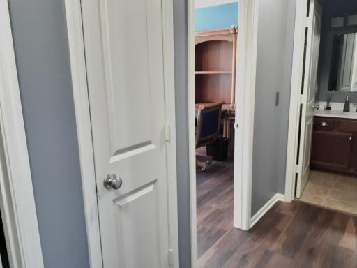 Hall closet between primary and Bedroom 2 and just across hall from laundry room