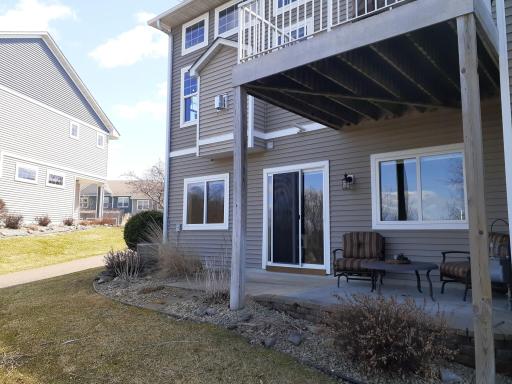 Back of home with semi-private deck and patio