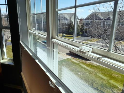 Large windows in primary bedroom with custom shades