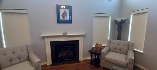 Clean inset custom shades and gas fireplace