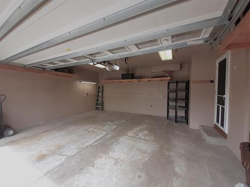 Completely finished garage with hanging shelves