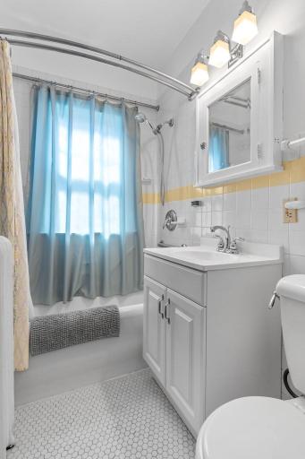 Tiled floors and walls. A shower and a deep tub are perfect for bathing.