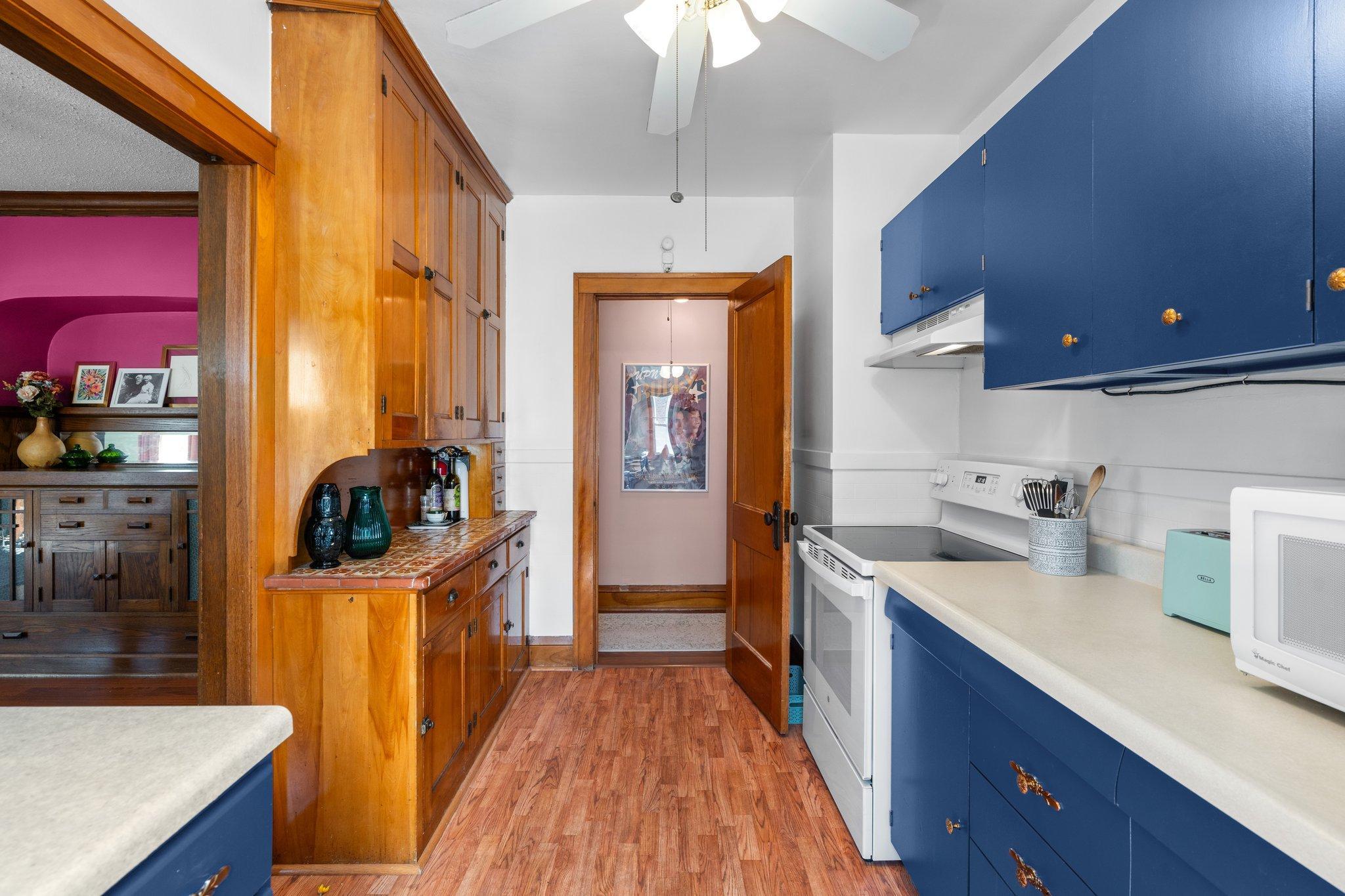 The hallway to the bedrooms is accessed through the kitchen.