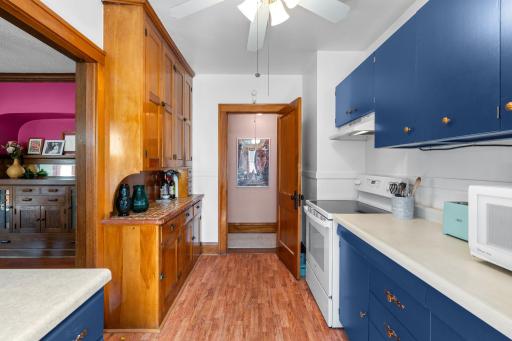 The hallway to the bedrooms is accessed through the kitchen.