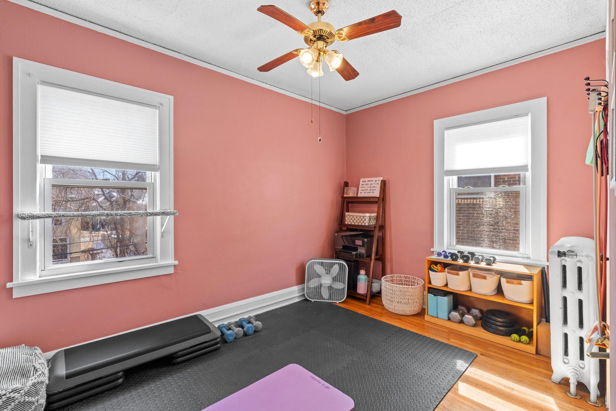 Bedroom number two has east and south-facing windows. Perfect to use as a bedroom, an exercise space, or as your home office!