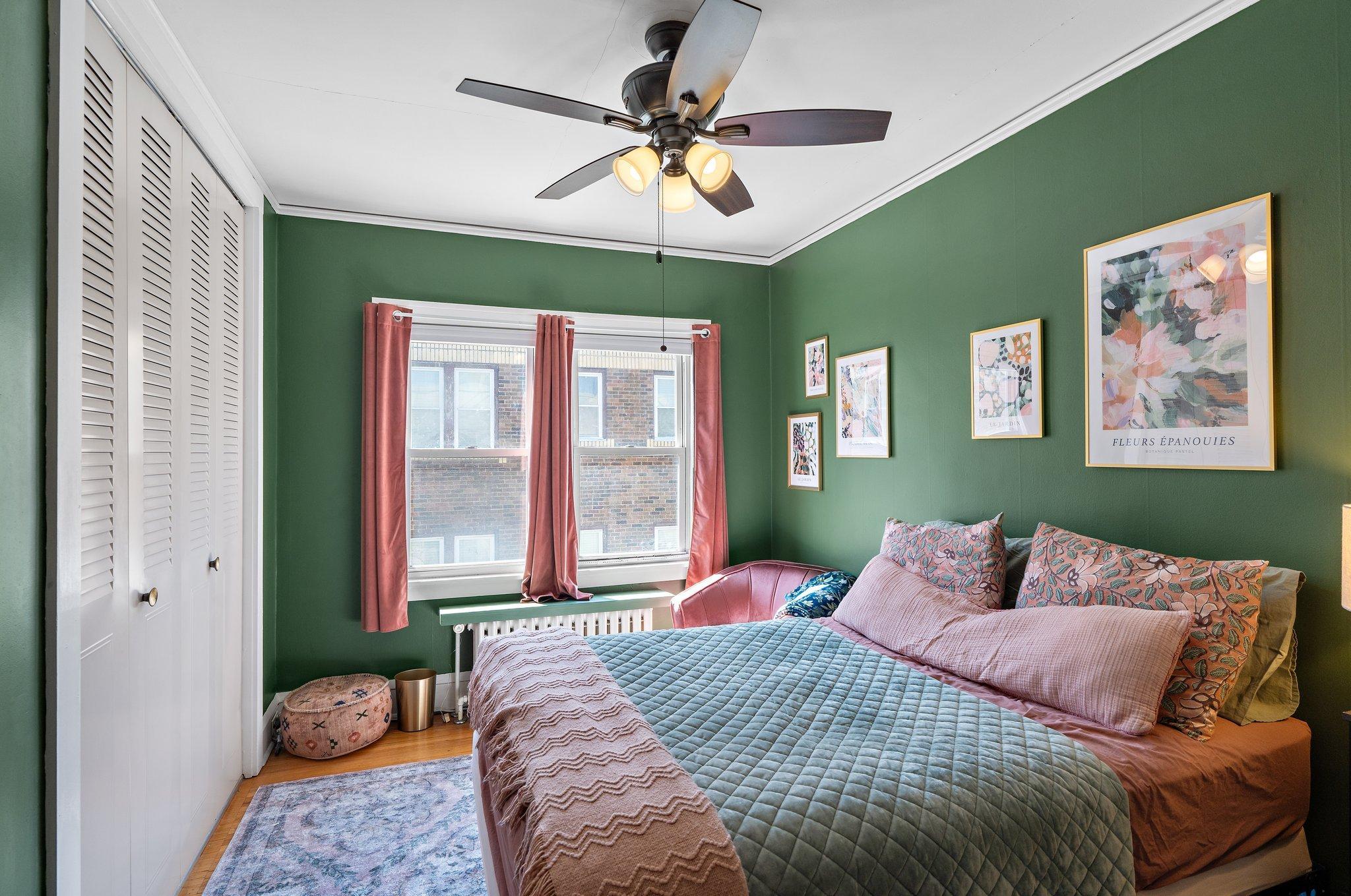 View of the middle/primary bedroom with plenty of closet storage.