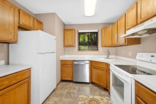 The kitchen window lets in some nature light.