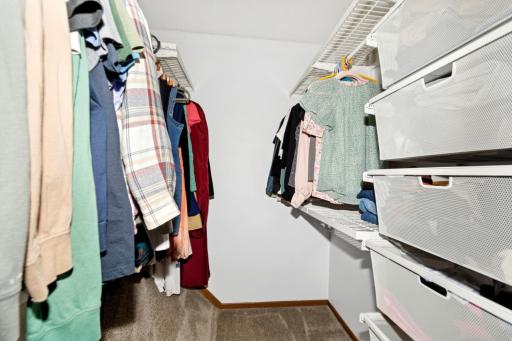 This walk in closet has pull out shelfing.