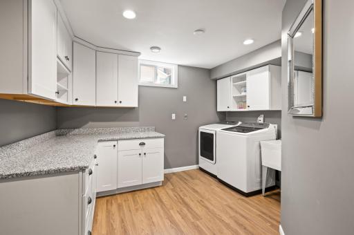 This laundry room! Spacious and clean - tons of storage. Get "Pintrest Perfect" organized!