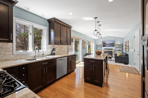 From the front door walk straight through to the center gathering spot: A well designed kitchen that flows right into the family room with sliding doors to the deck in between. This home as seen some entertaining!
