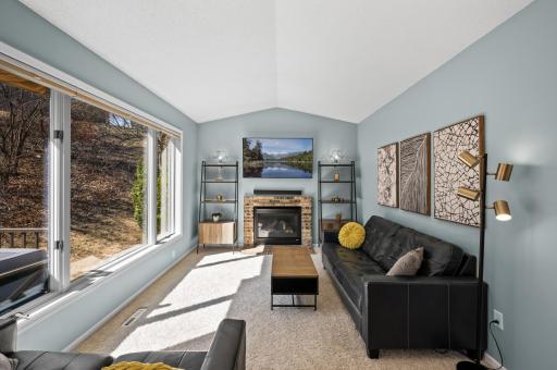 Bright vaulted family room area featuring gas fireplace