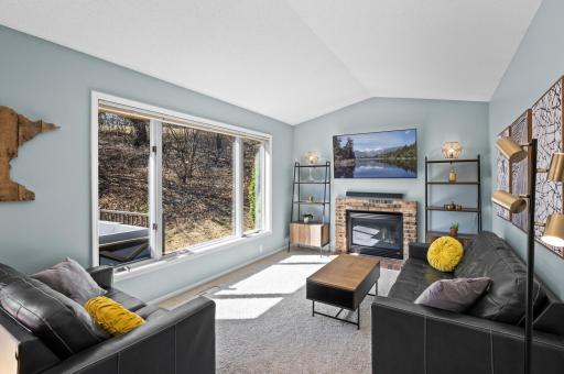 Can a family room be both bright a cozy? This one is! With a large picture window and vaulted celling that creates a spacious feel, the woods in back and gas fireplace create a warm vibe.