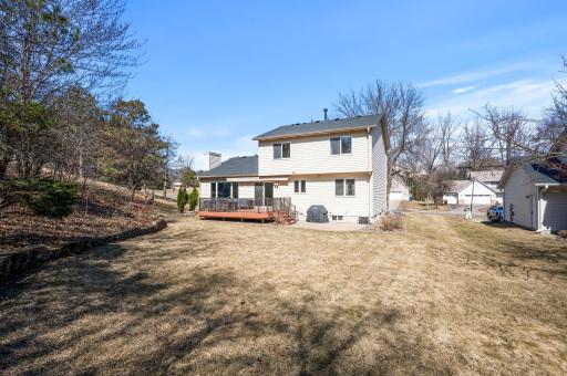 Wedge shaped backyard has plenty of sunny space for raised beds or a garden while the woodsy hill off to the side offers a feel of privacy.