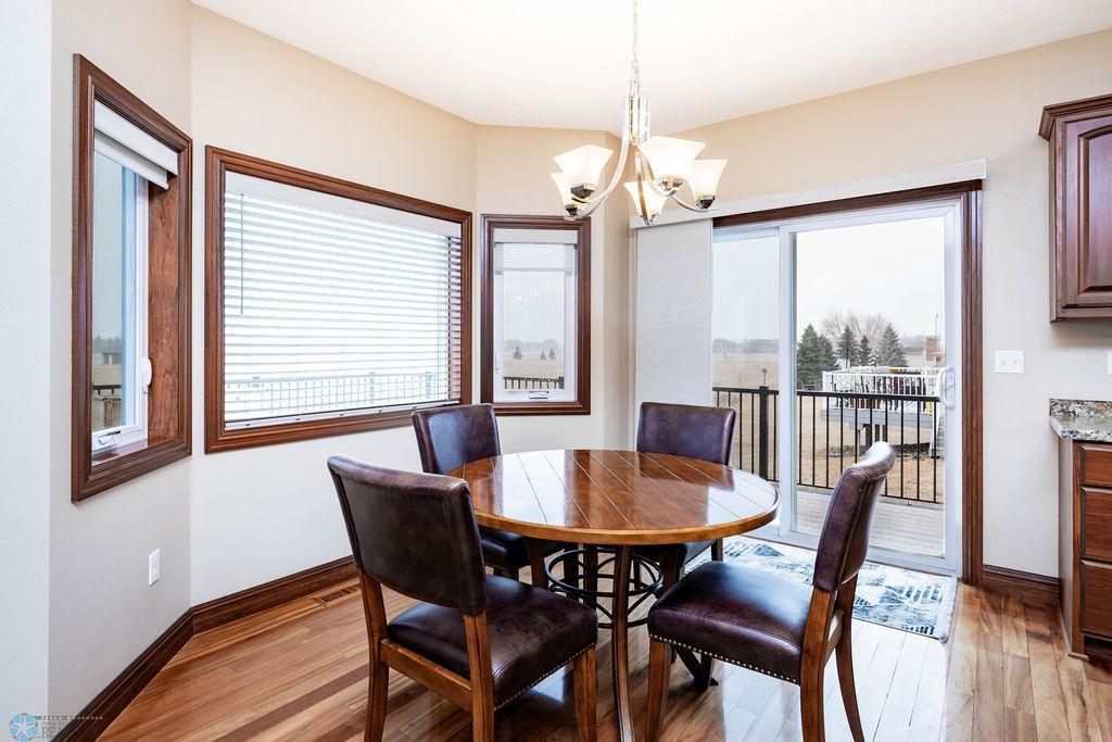 Dining area with views to backyard & patio door to large maintenance-free deck