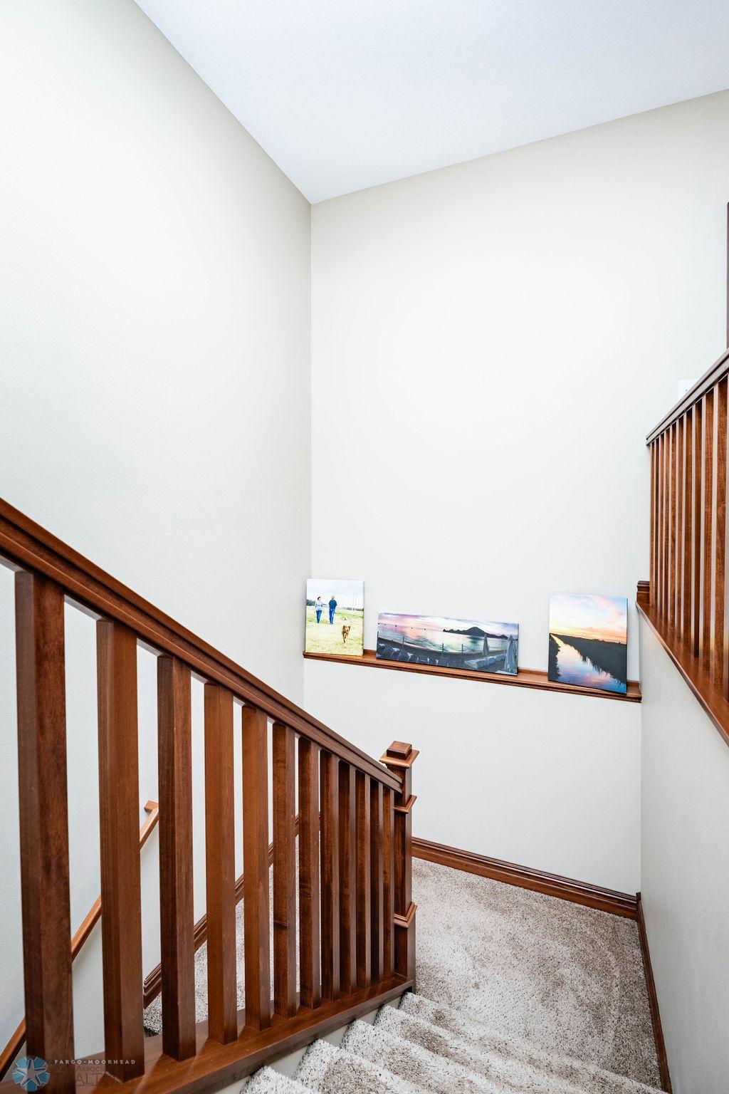 Open wooden staircase with display ledge