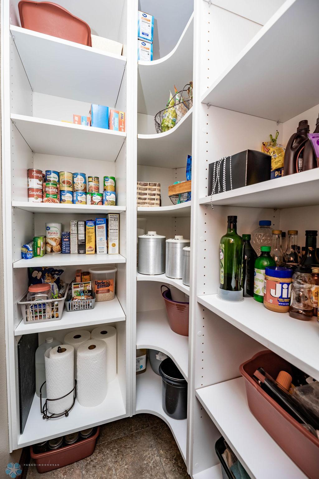 Walk-in pantry fitted with shelves for food & kitchen storage!