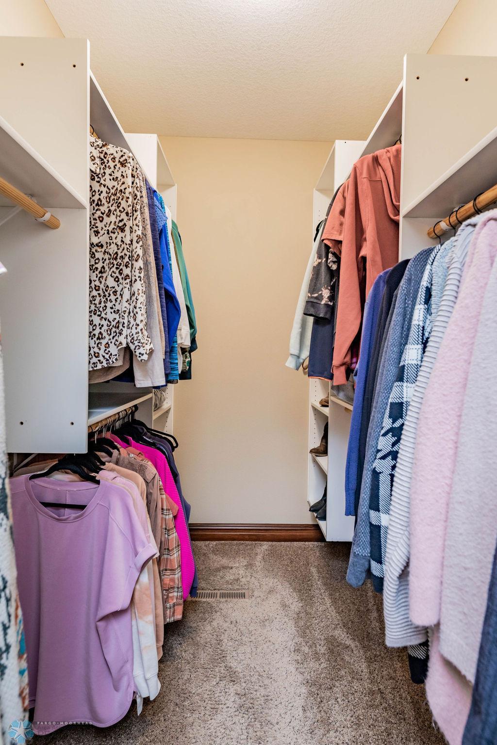 Walk-in closed fitted with shelving and hanging space.