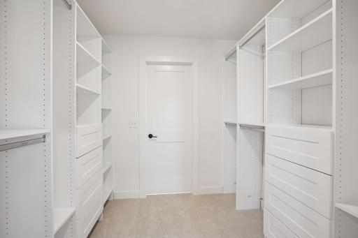 Primary Suite Walk in Closet with Access to Upper Level Laundry Room