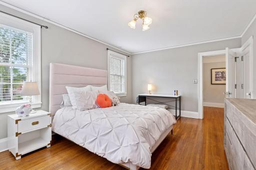 Third bedroom features windows, hardwood floors and nice sized closet.