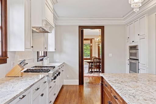 The kitchen seamlessly flows into the formal dining room. Plus, a beautifully crafted pocket door adds a touch of classic charm and smart design.