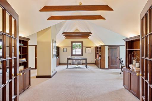 Natural woodwork throughout the space enhances its inviting atmosphere and the thoughtfully designed built-ins are seamlessly integrated into the space, offering both storage and display options.