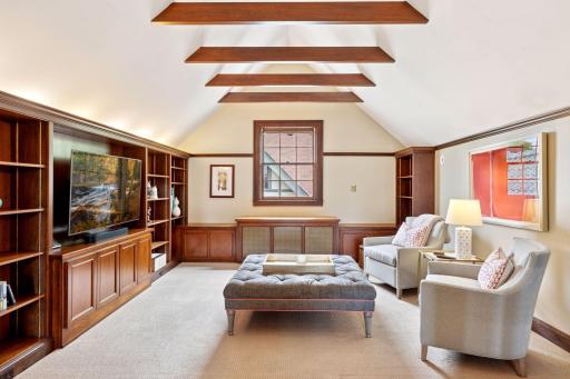This upper area exudes warmth and sophistication! Custom built-ins crafted with rich, dark cabinetry- perfectly framing the room with timeless style.